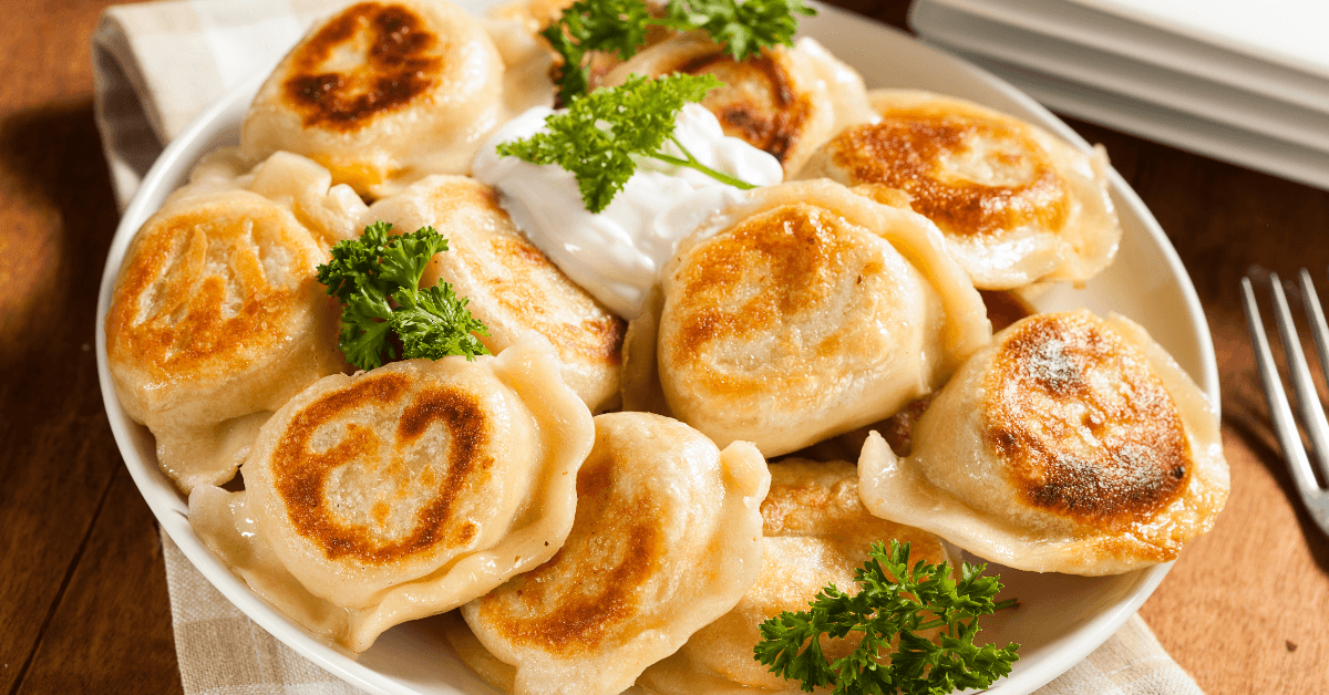 Plate of pierogis and sour cream