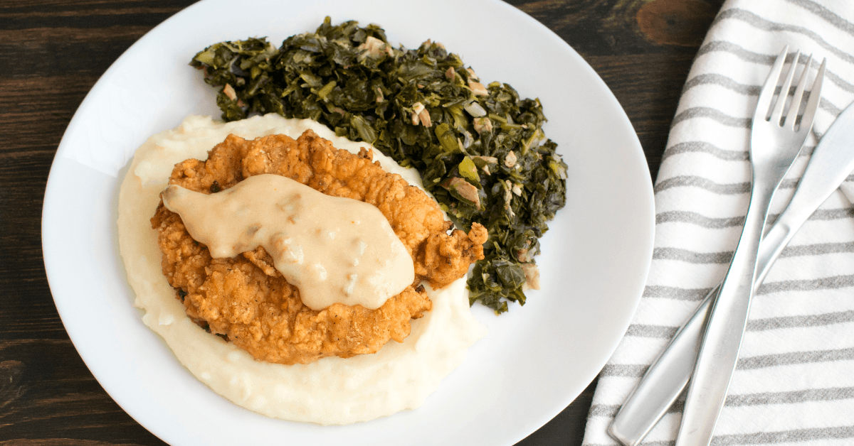 Chicken fried steak with mashed potatoes and collard greens