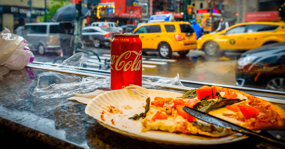 Piece of pizza and Coke in New York restaurant