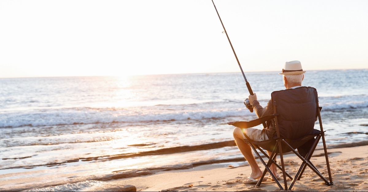 senior man fishing at sea side 