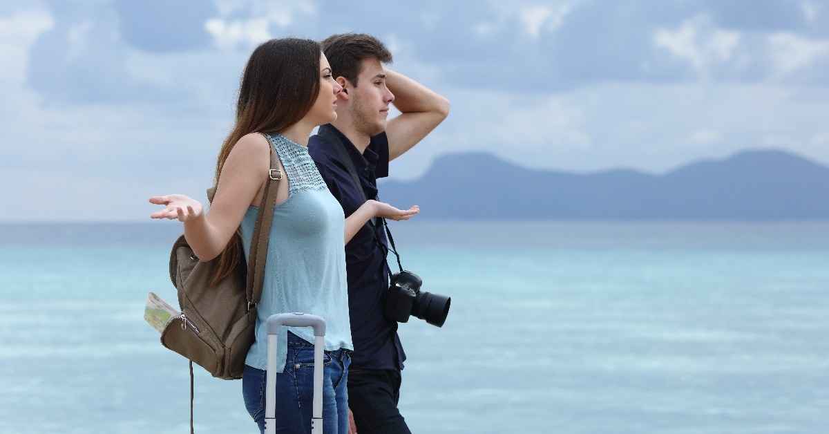 angry couple complaining on a cloudy vacation