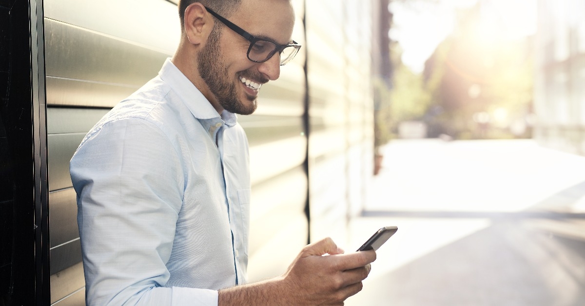 young handsome man using smartphone