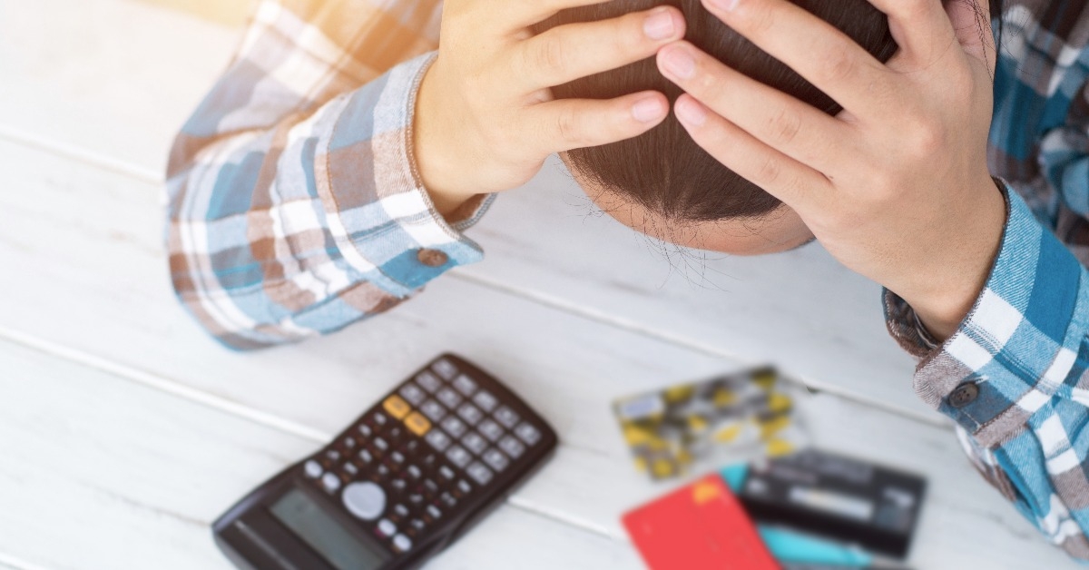 stressed woman using credit card