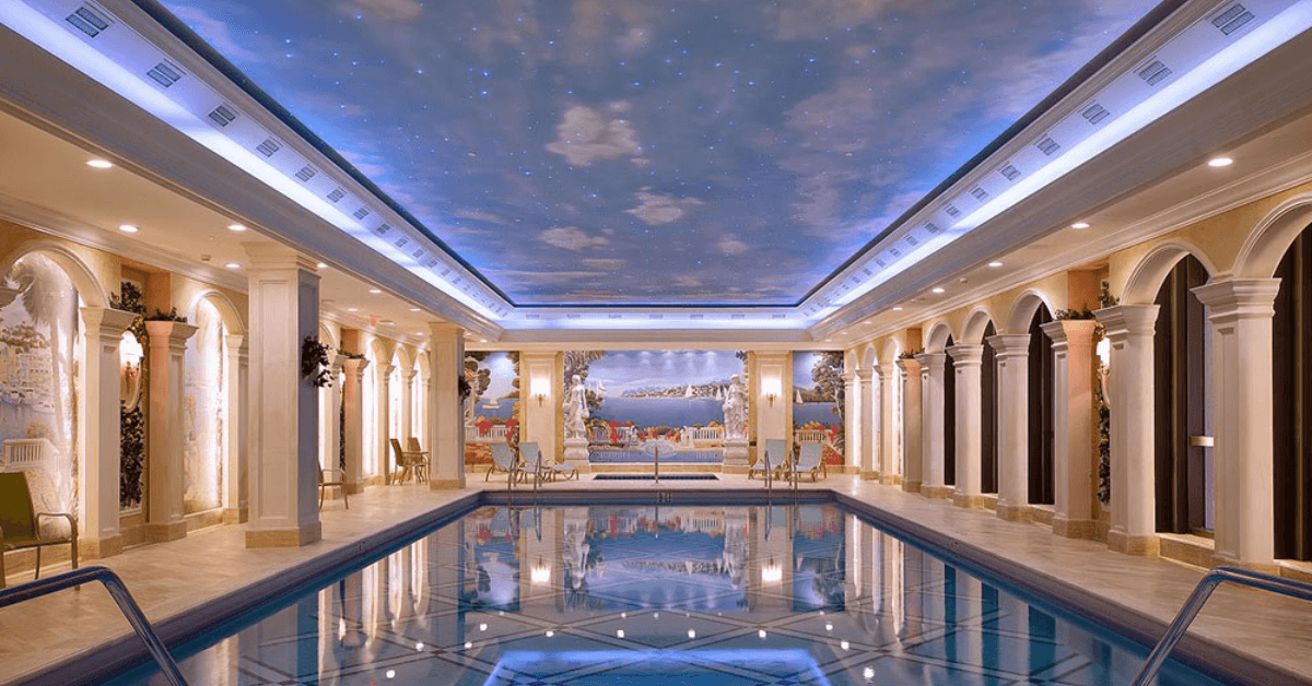 Indoor pool with painted sky ceiling