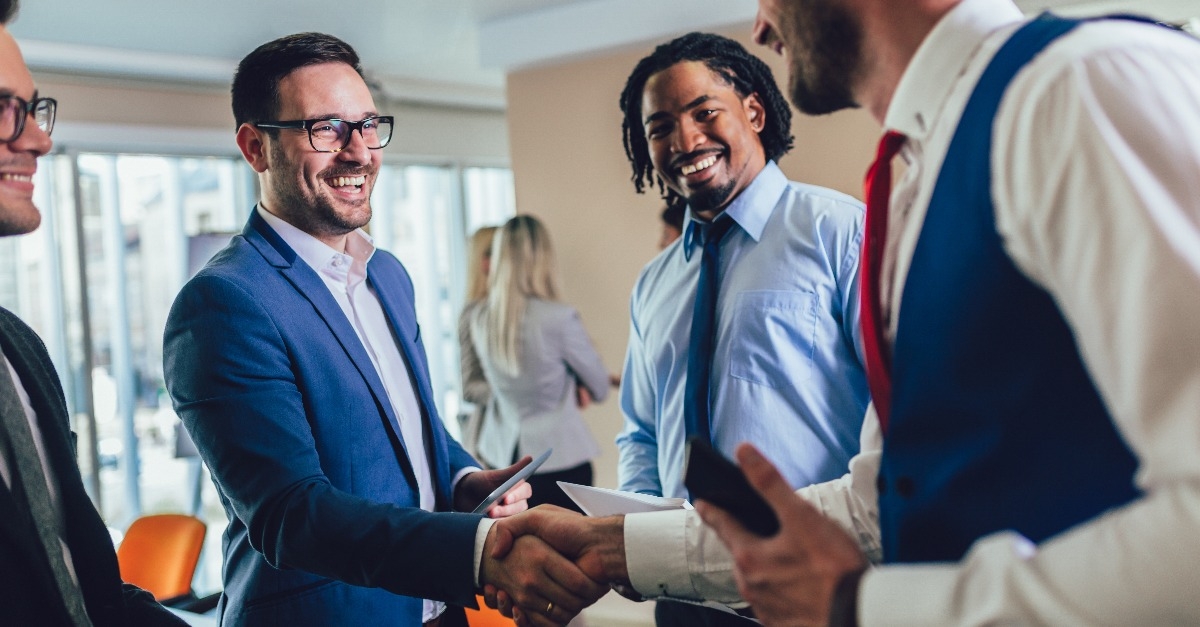 happy businessmen handshaking after negotiation