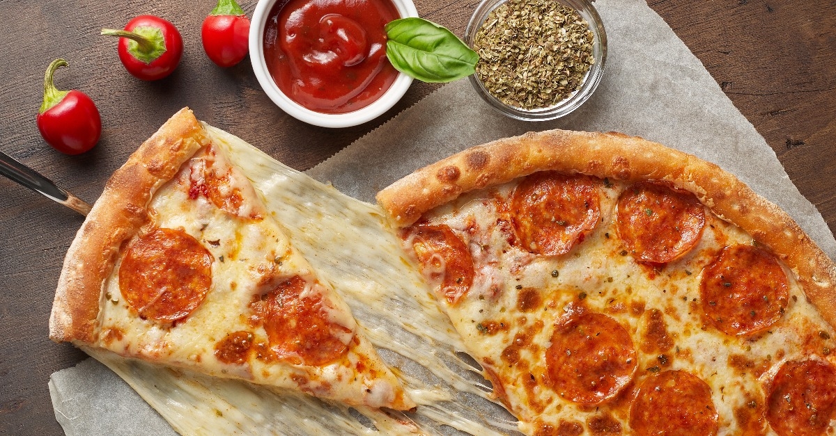 slice of hot pizza with melting cheese and chorizo