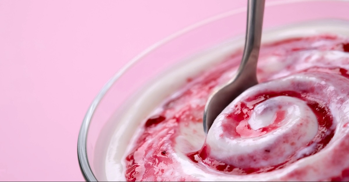 yogurt with berry jam in spoon
