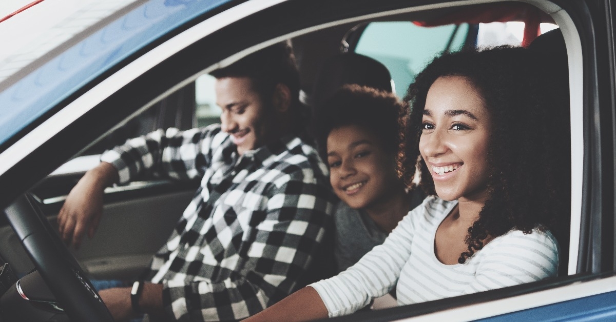 african american family at car dealership