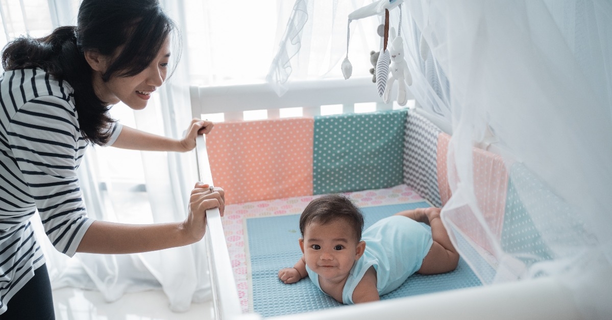 happy  asian baby on the crib