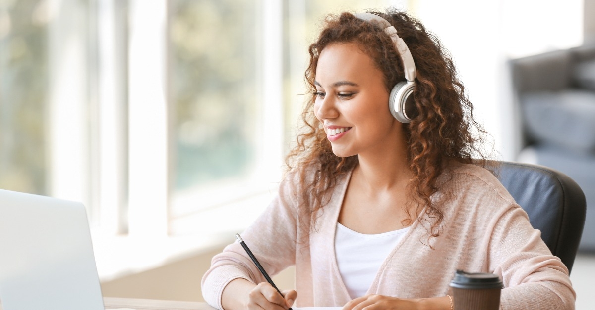 female student listening to music while preparing for exam