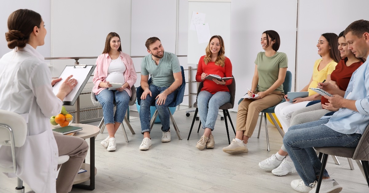 group of pregnant women with husbands and doctor