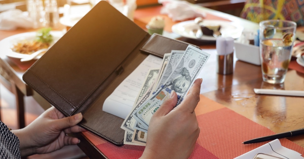 hand of a woman with an american dollar bills