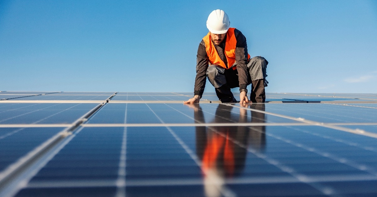 handyman installing solar panels on the rooftop