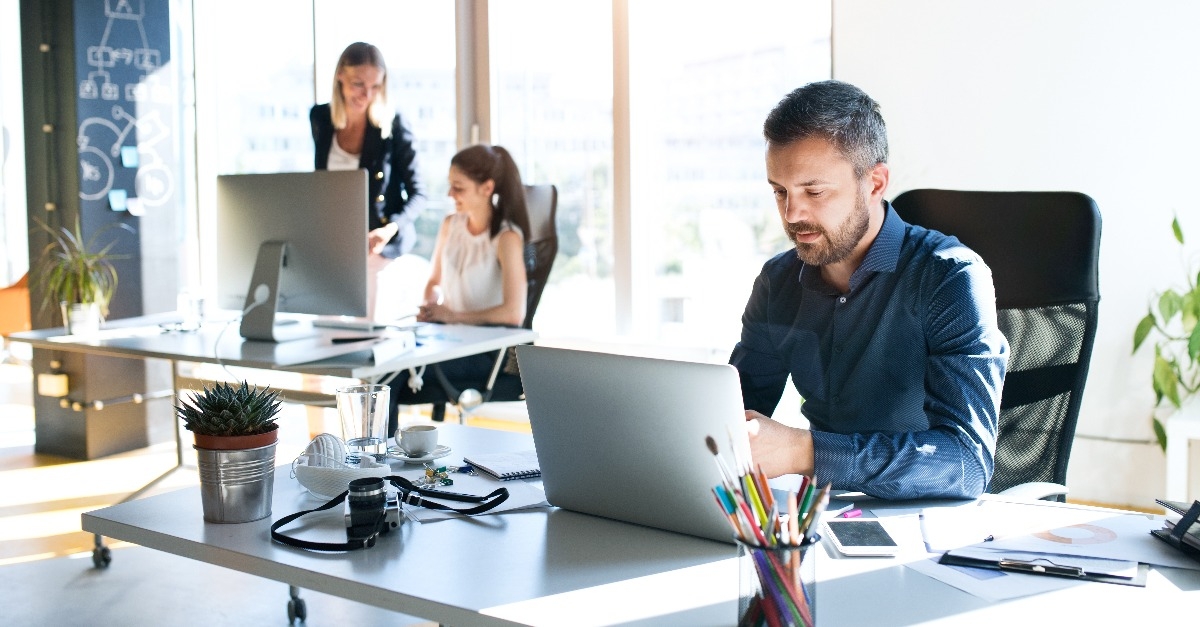 three business people in the office working together
