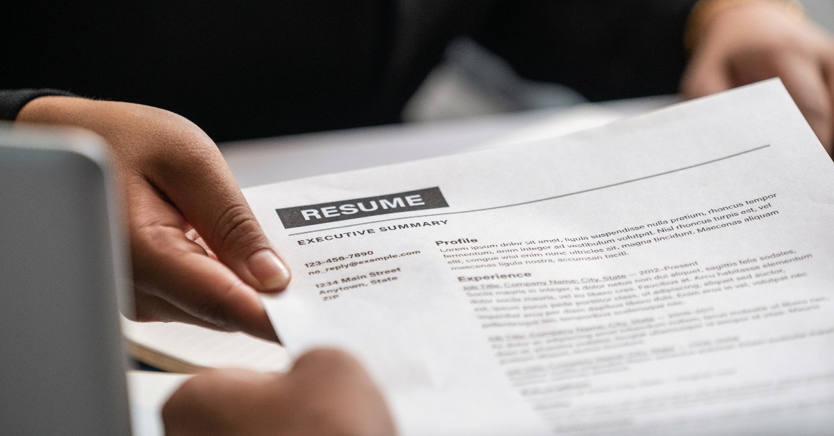 close up view of employee candidate handing resume