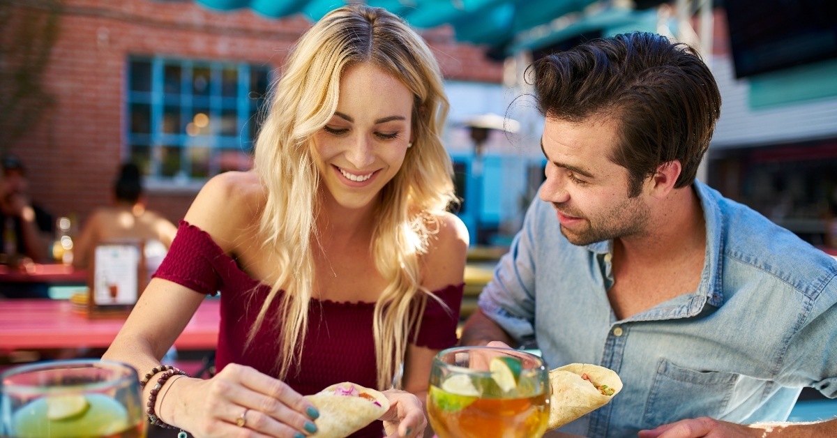 Happy couple eating dinner at restaurant