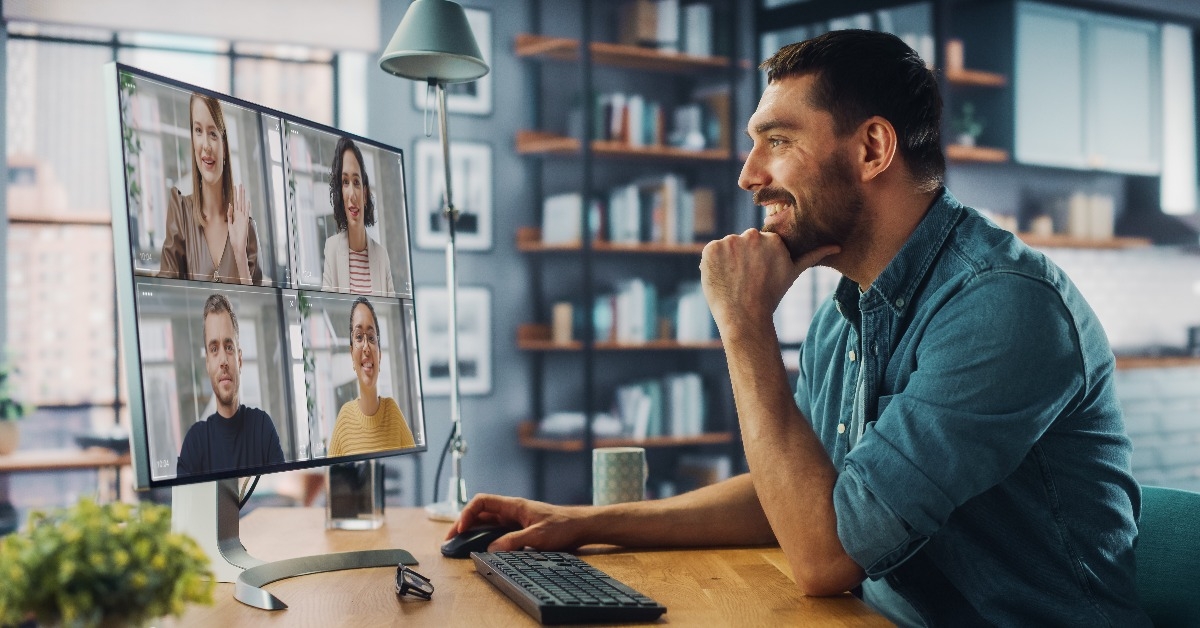 handsome caucasian specialist making a video call on desktop computer