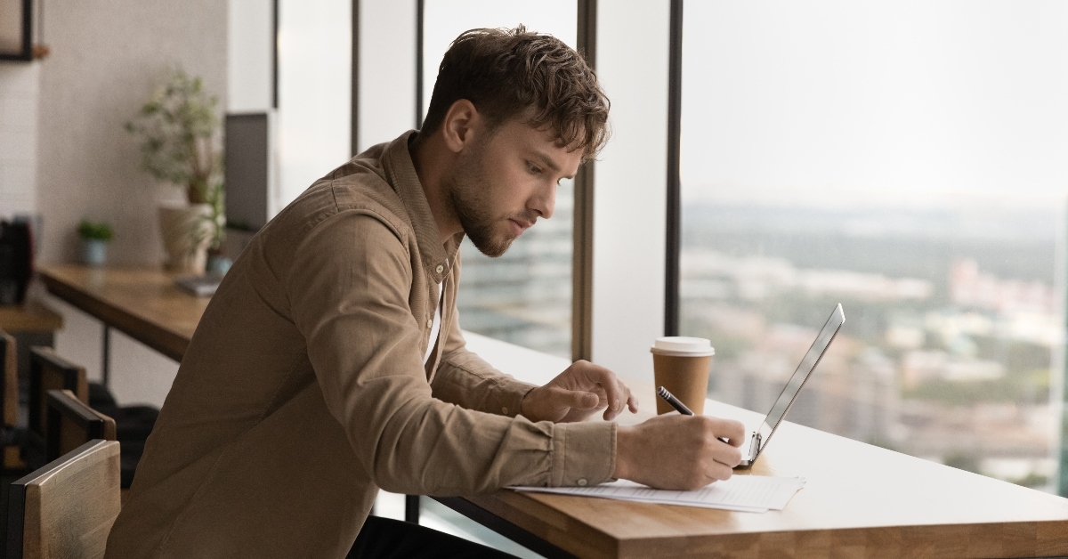 Man working on computer in cafe