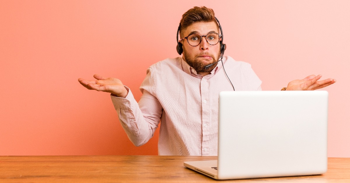 young man working in a call center confused