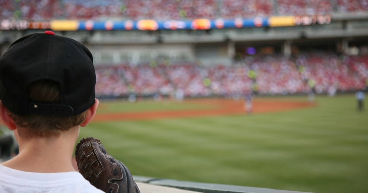 Kid watching baseball game