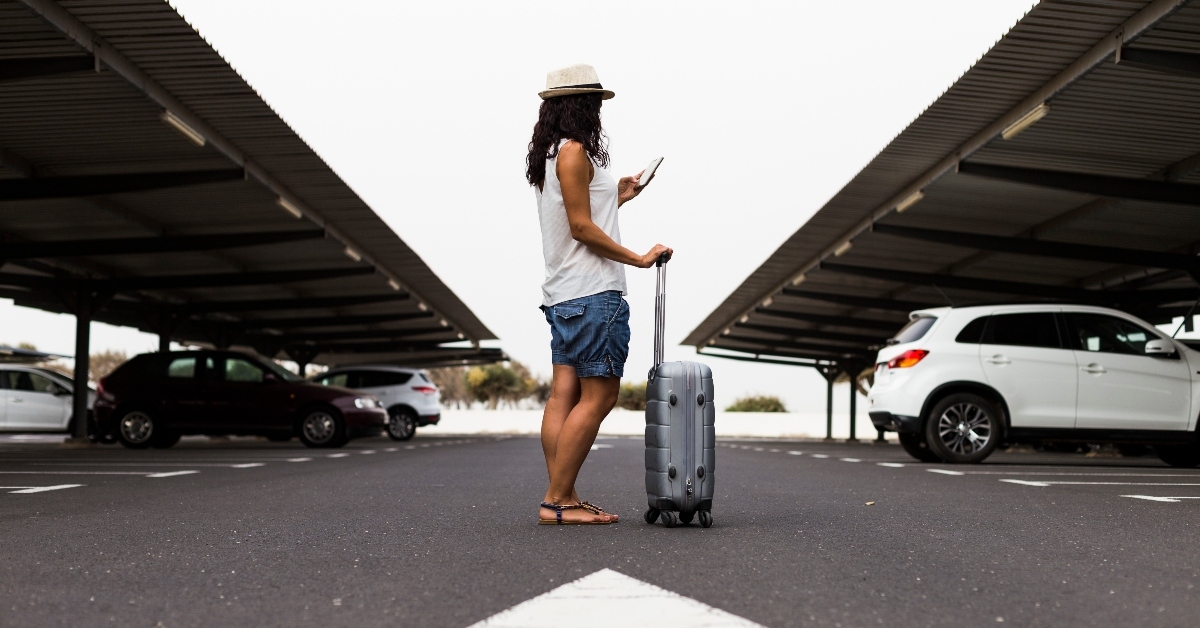 Woman waiting in airport parking lot