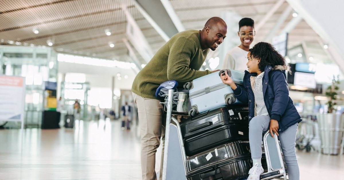 Happy family at airport with luggage