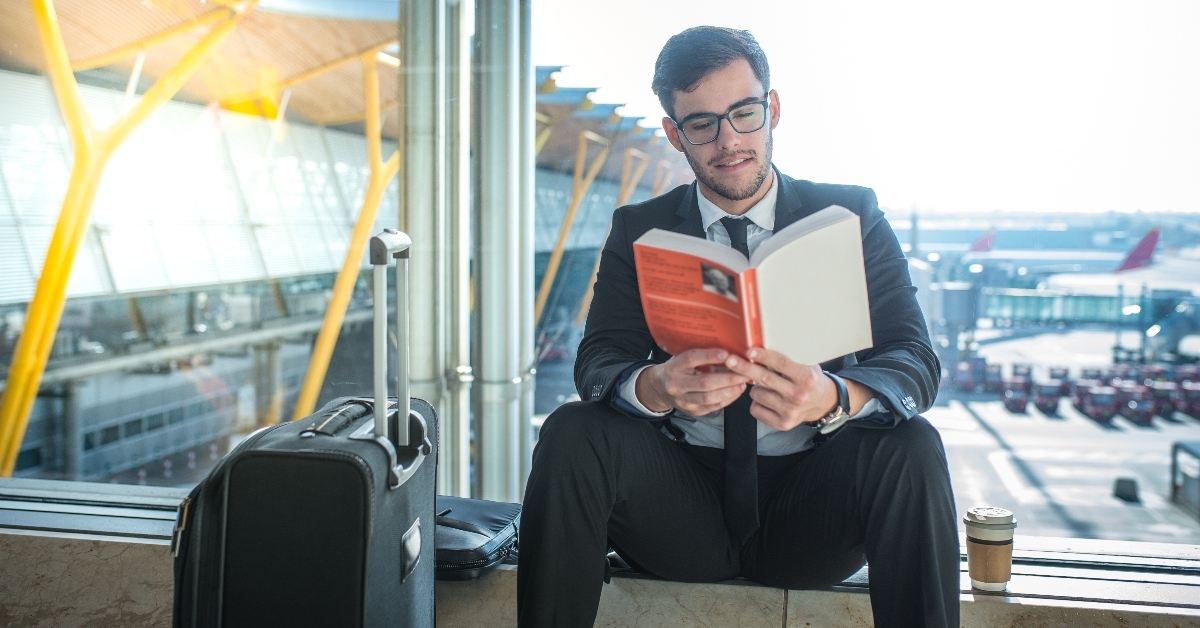 Man reading book at airport