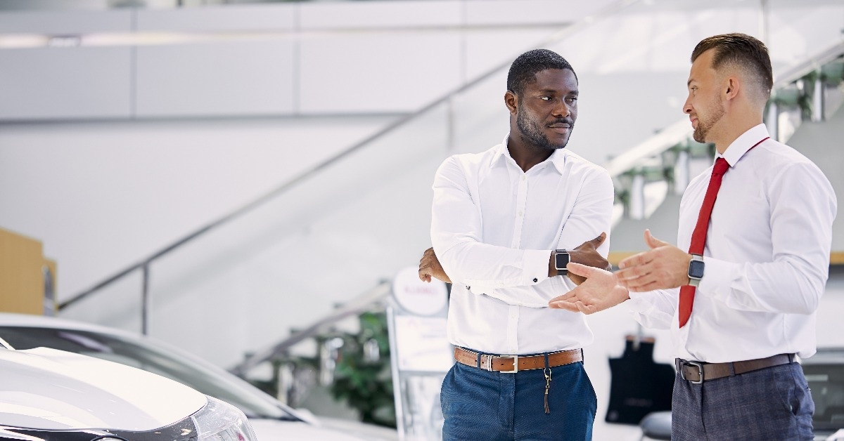 car salesman talking to a client