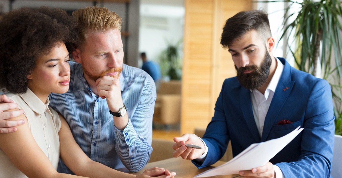 young couple talking to their estate agent