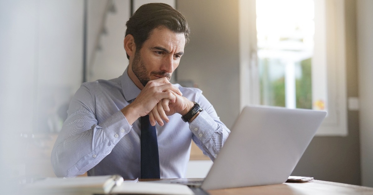businessman concentrating on laptop in modern office