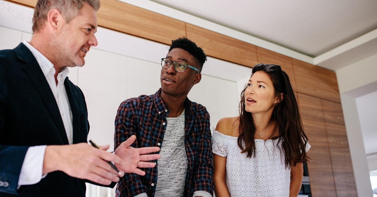 interracial couple having consultation with a realtor