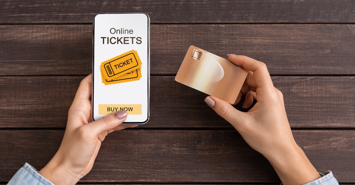 woman buying event tickets via app on smartphone and credit card