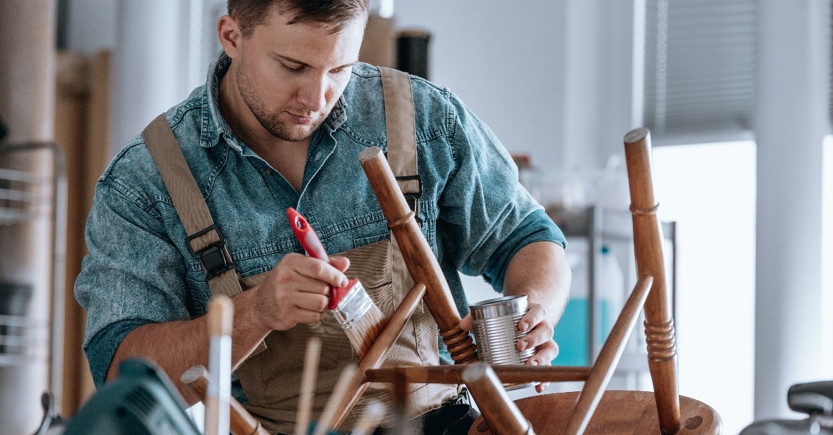 carpenter painting wooden chair