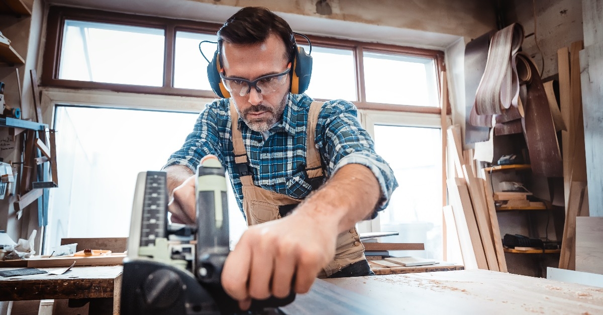 carpenter working on woodworking in carpentry workshop