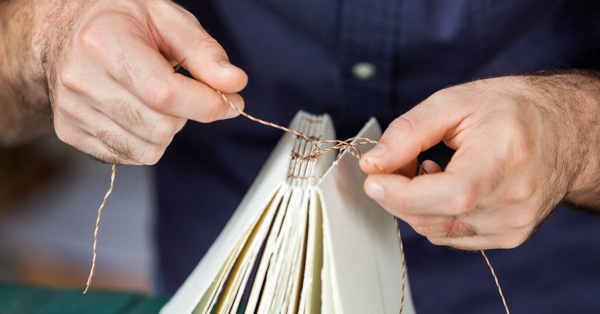 male worker binding pages