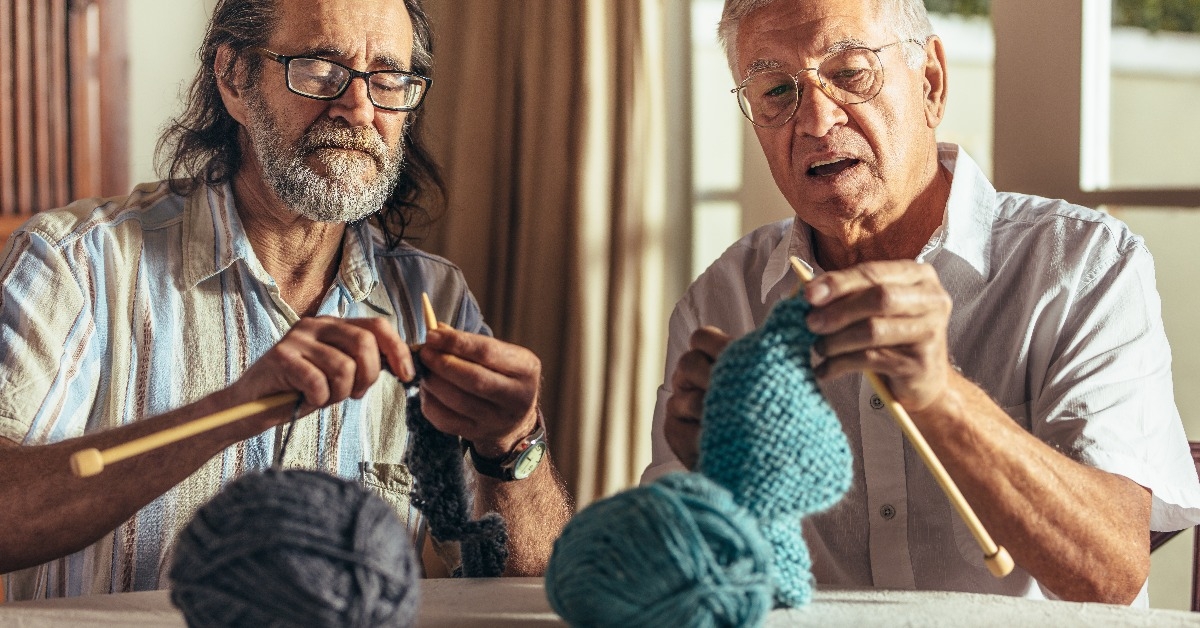 senior men knitting at home