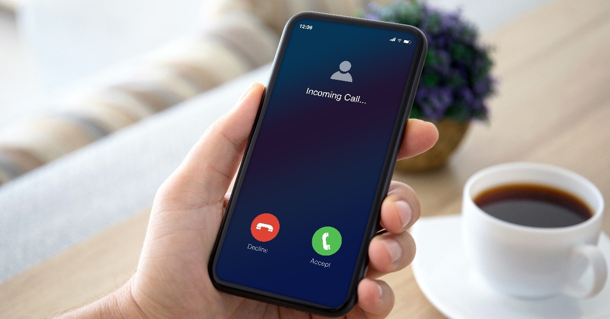 male hands holding phone with incoming call on the screen