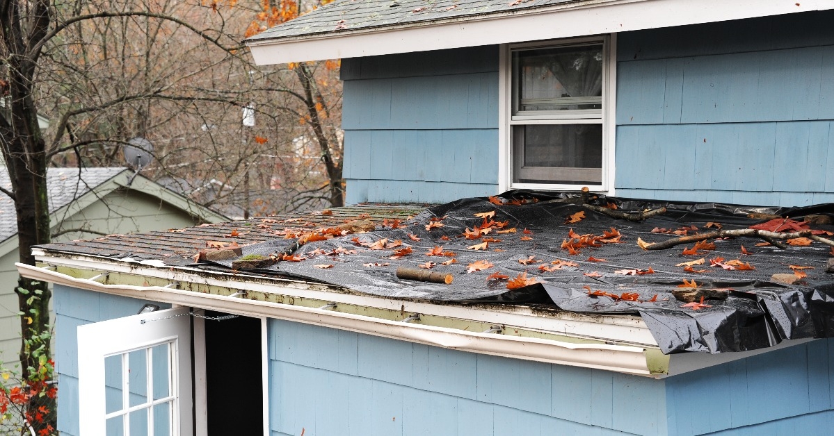 house roof damaged in hurricane storm