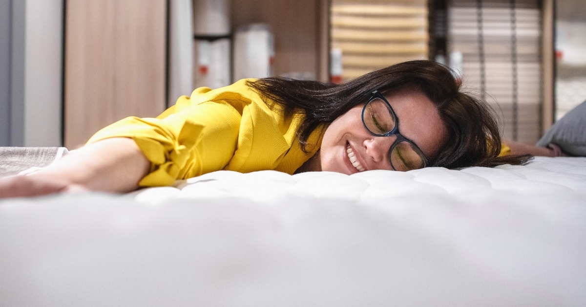 girl is testing a new mattress before buying