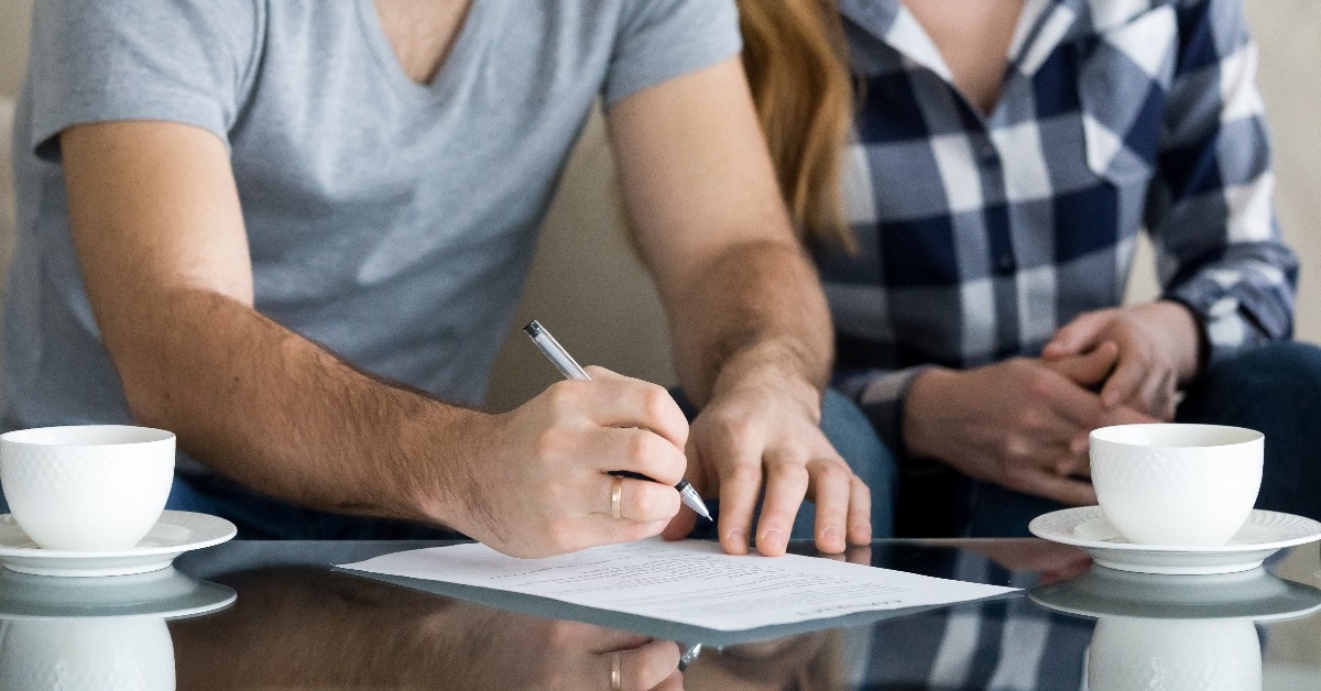 tenants write signature on rental sale agreement