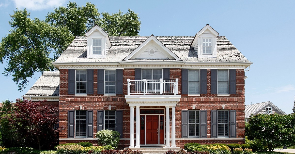 brick home with front balcony