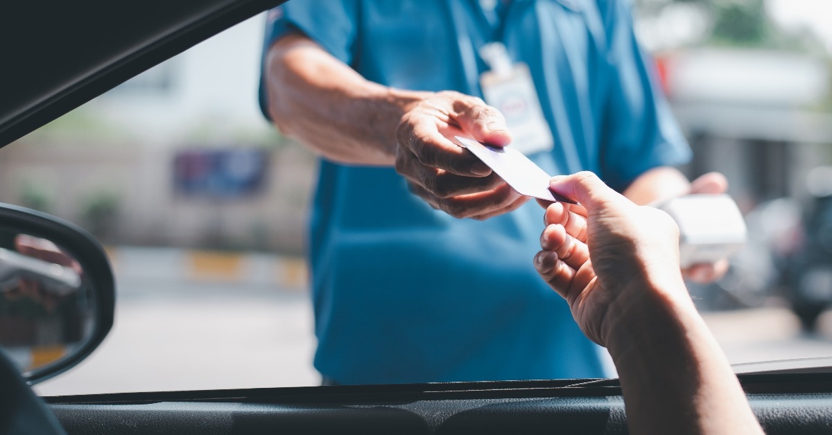 traveler man car owner paying fuel pump with credit card