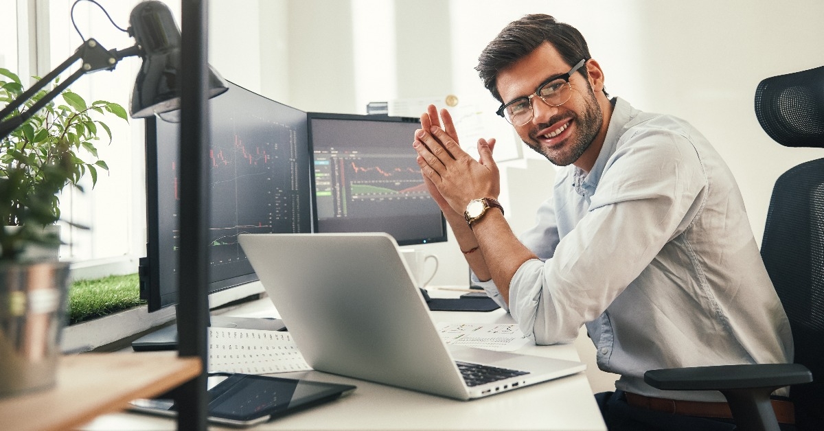 happy bearded trader in formal wear and eyeglasses