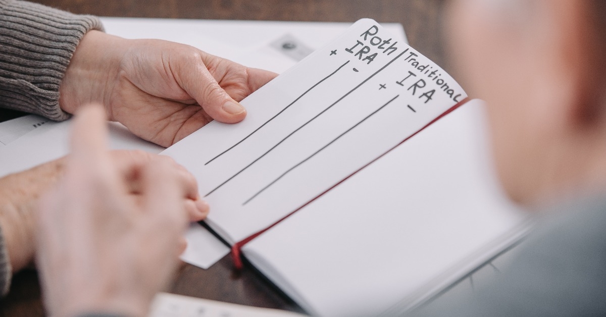 senior couple holding notebook with roth ira