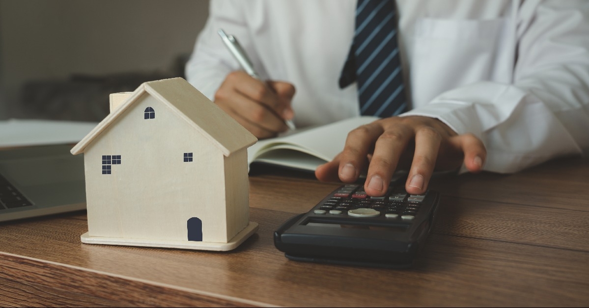 wooden house model with young Asian agent 