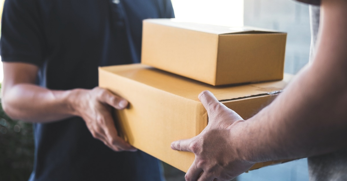 accepting of cardboard boxes package from postman