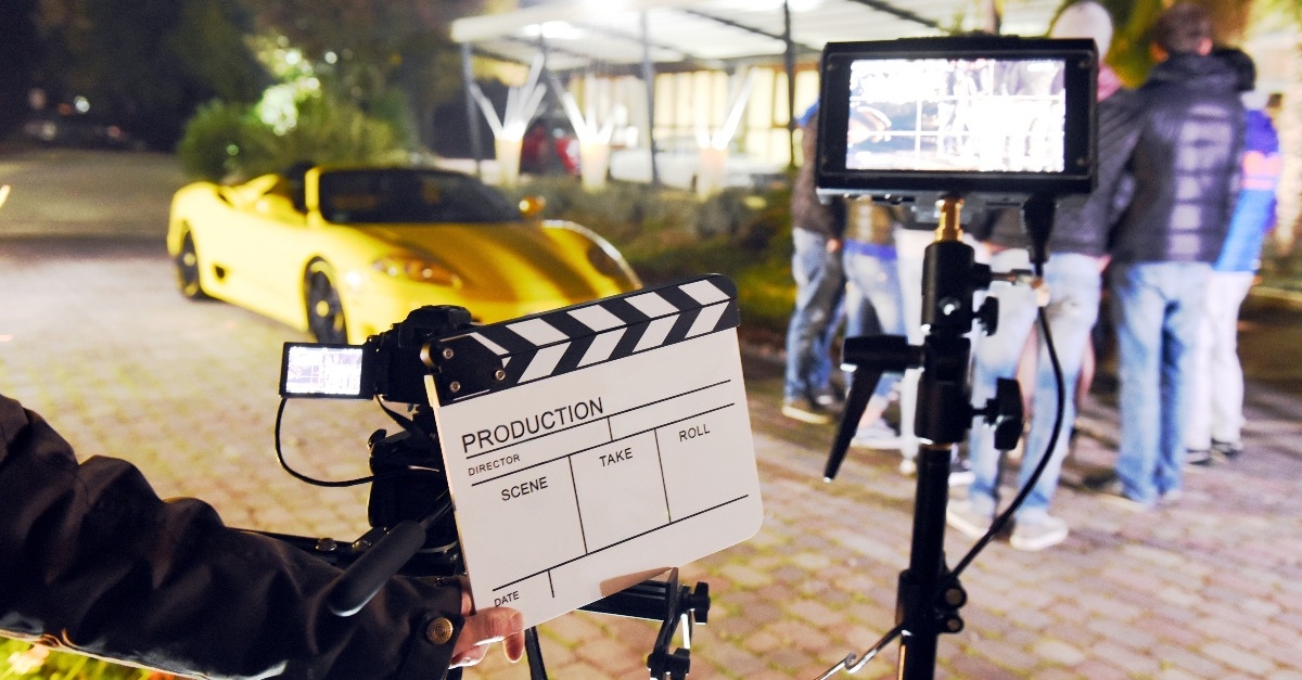 operator holding clapperboard during the production of short film 