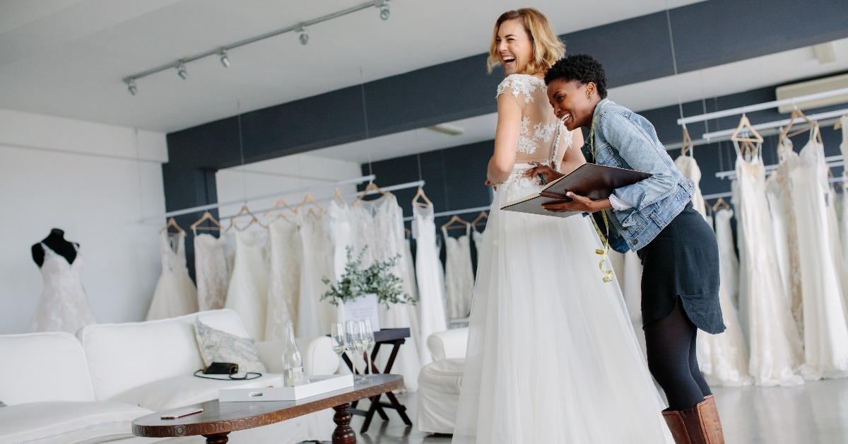 female trying on wedding gown 