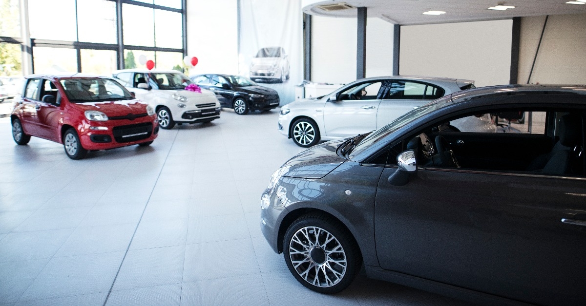 car dealership showroom interior with brand new vehicles for sale