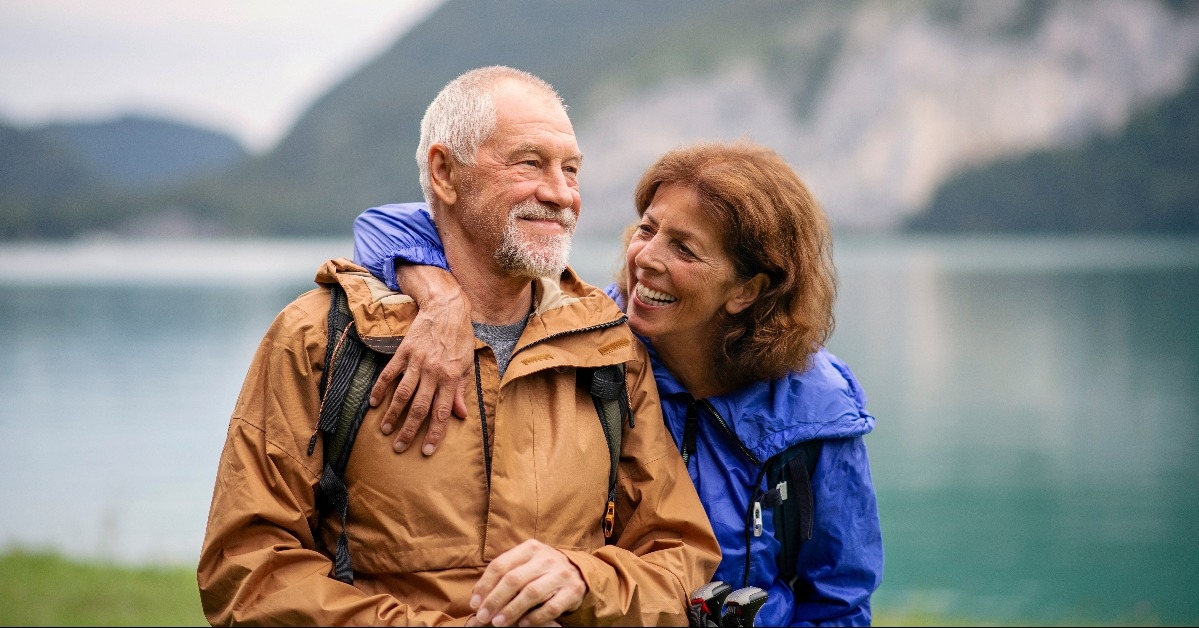 senior couple hiking by lake